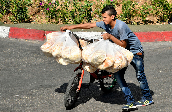 "Bread on a Bike" (2017):  Young boy delivering breads on a bicycle, Ramallah.