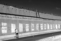 "Banality of Evil" (2014).  A Palestinian sweeping up debris in the shadow of the Wall, Ar-Ram.