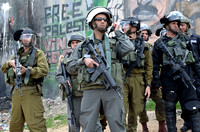 "Land Day" (2012):  Israeli soldiers readying weaponry against protestors at Qalandia on Land Day.