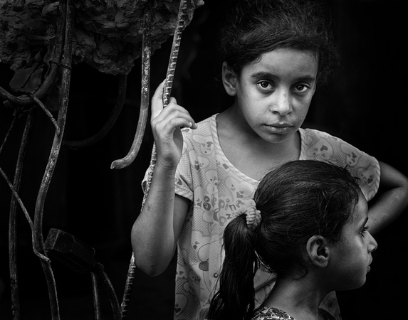 "All That Remains (2014): Young girls amid remains of their home in Gaza City destroyed in 2014.