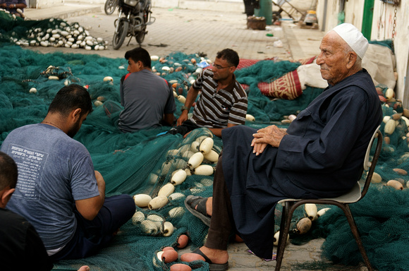 "Mending Nets" (2017): Family mending fishing nets, Gaza City Port.