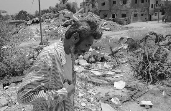 "Silent Suffering" (2014):  A man from Zeina, Gaza Strip in front of his house destroyed by Israel.